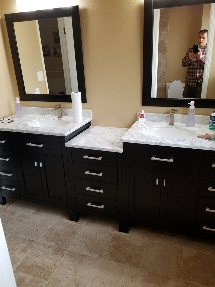New vanity and double sinks with granite countertops installed in bathroom in San Jose home by Kevin's Handyman