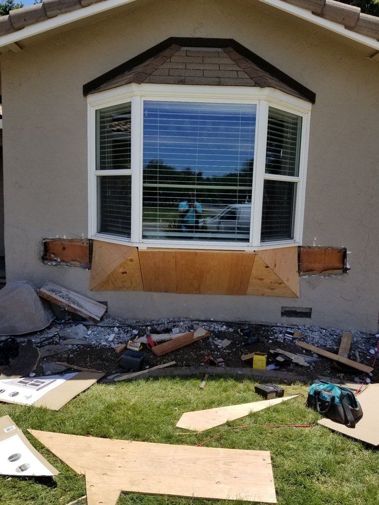 In-progress shot of custom carpentry being installed around the exterior of a bay window