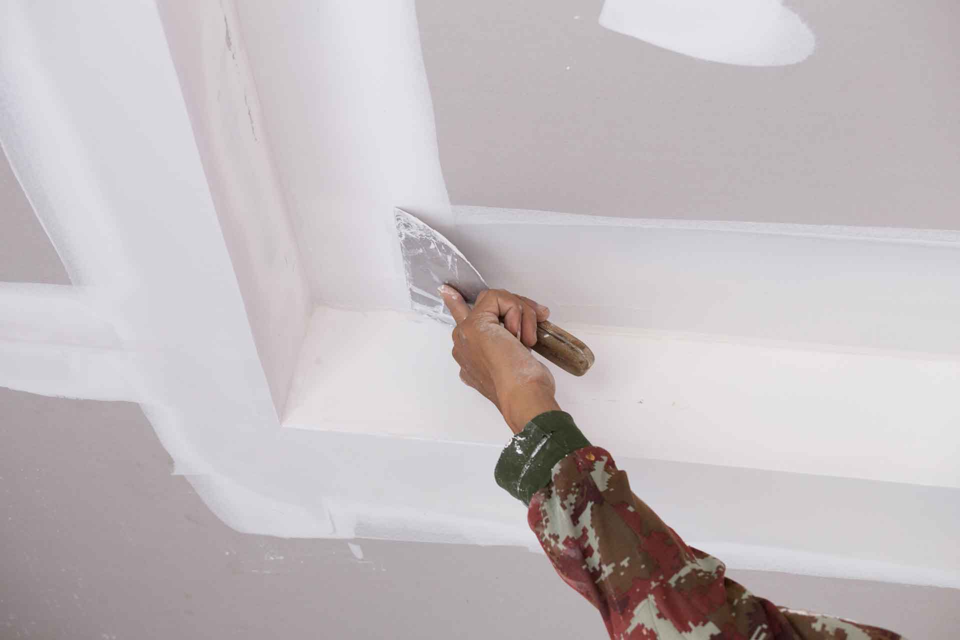 Handyman tapes up drywall
