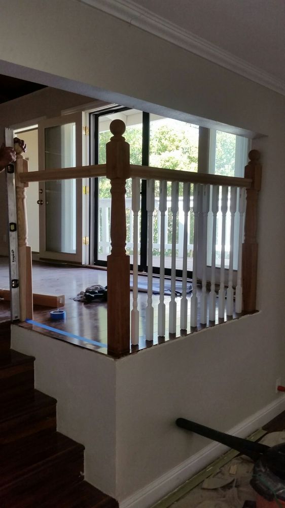 In-progress shot of new custom fabricated wooden railing being installed around stairs in San Jose home