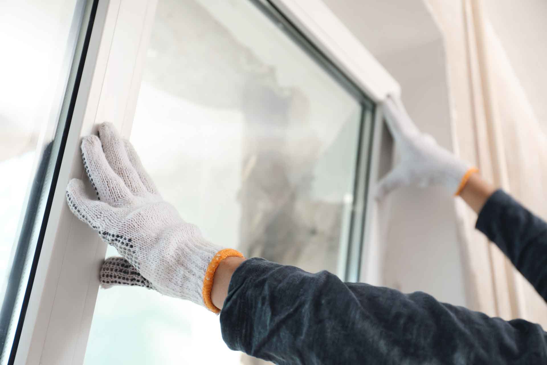 A handyman installs a new window